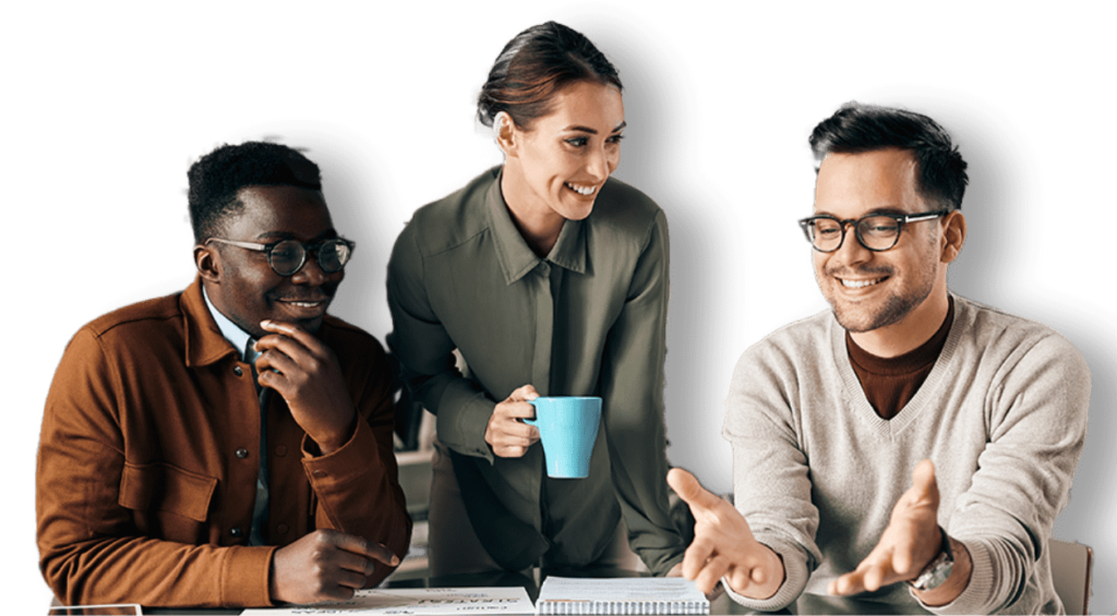 2 men a sat down smiling talking to a lady holding a mug