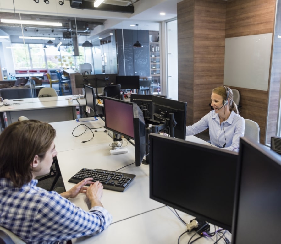 A lady on a help desk helping somebody